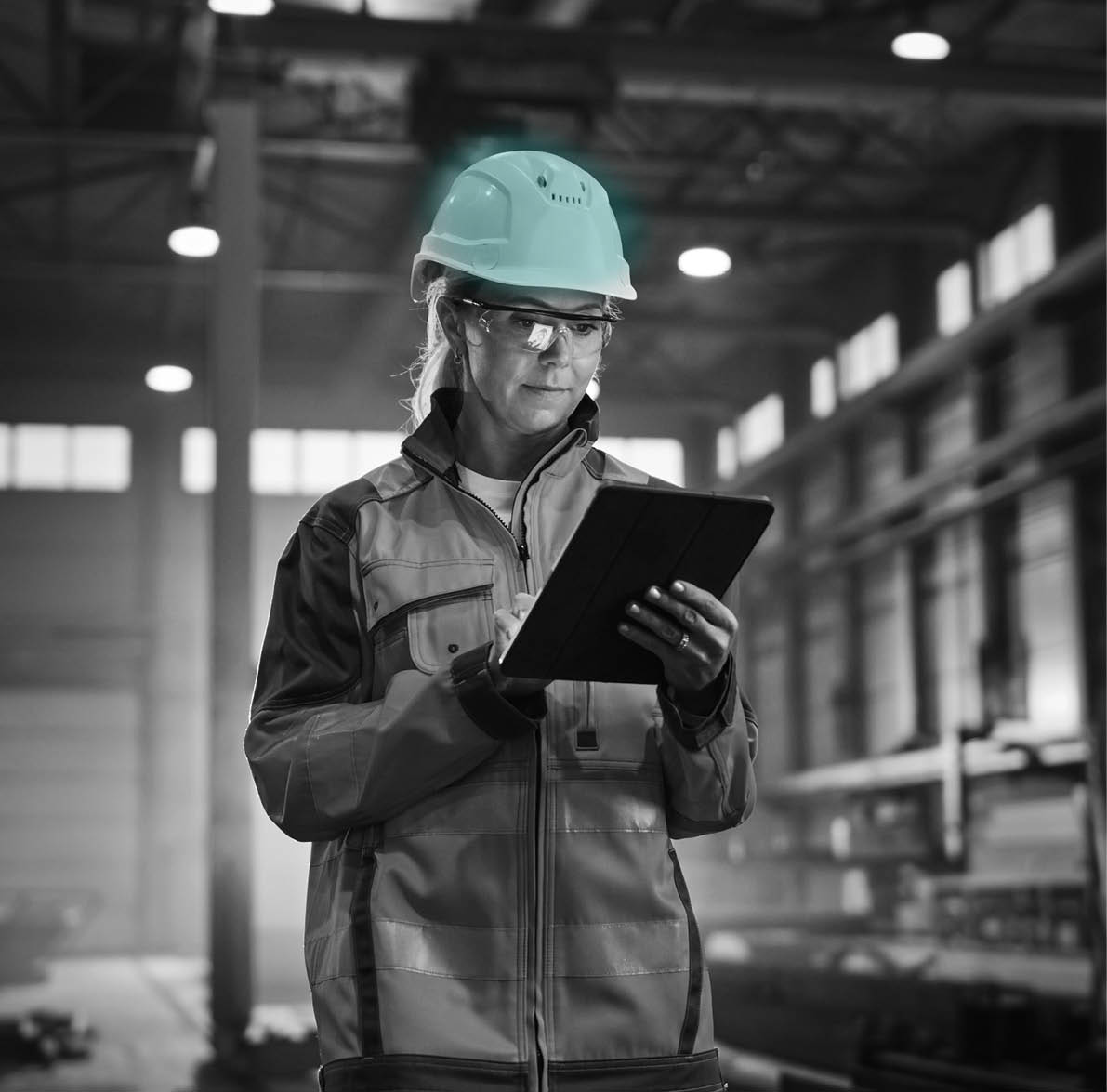 Professional Heavy Industry Engineer Worker Wearing Safety Uniform and Hard Hat, Using Tablet Computer  Serious Successful Female Industrial Specialist Walking in a Metal Manufacture Warehouse 