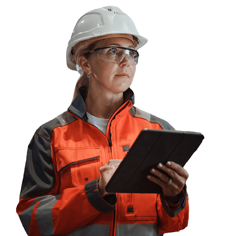 Professional Heavy Industry Engineer/Worker Wearing Safety Uniform and Hard Hat Uses Tablet Computer. Serious Successful Female Industrial Specialist Walking in a Metal Manufacture Warehouse.